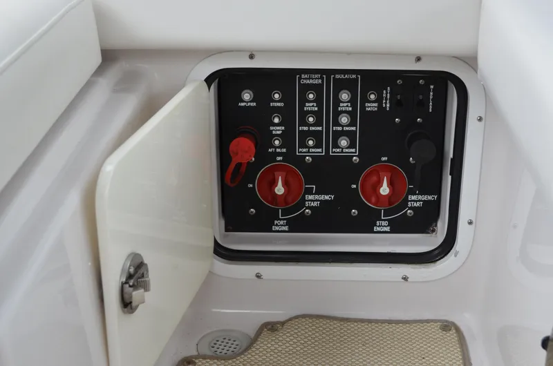 Slide: The Image of Control panel of a 2013 Four Winns H310 boat with emergency start switches. - 22