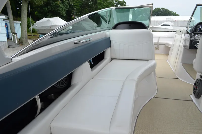 Slide: The Image of 2013 Four Winns H310 boat interior with white seating and modern design. - 23