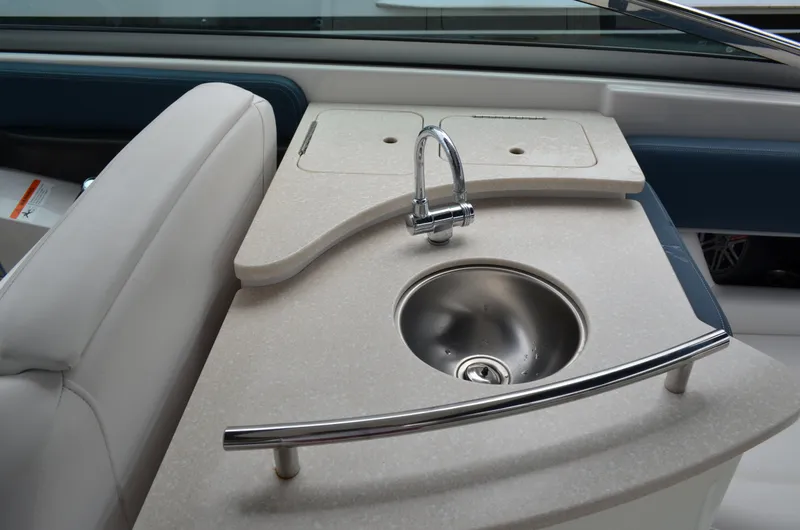 Slide: The Image of 2013 Four Winns H310 boat interior with sink and faucet. - 26