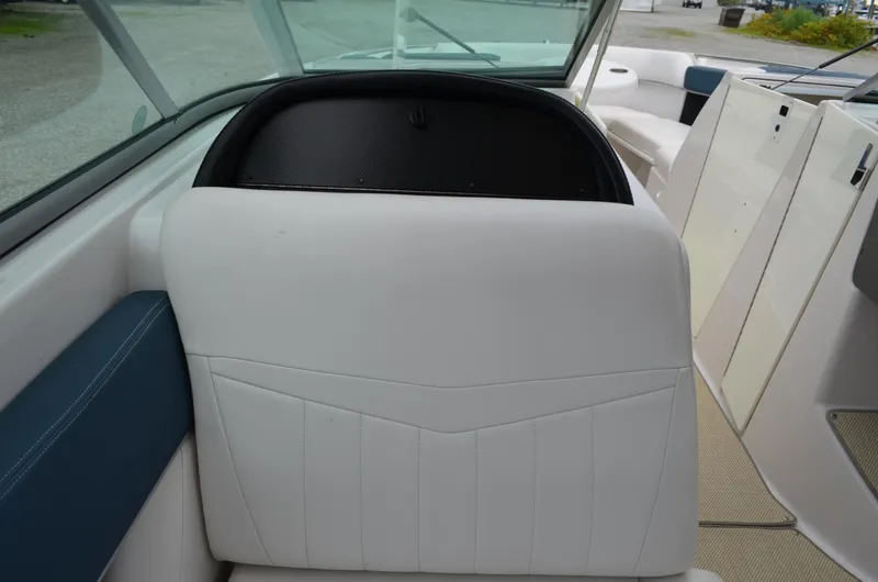 Slide: The Image of Interior seating of 2013 Four Winns H310 boat with white upholstery and blue accents. - 30