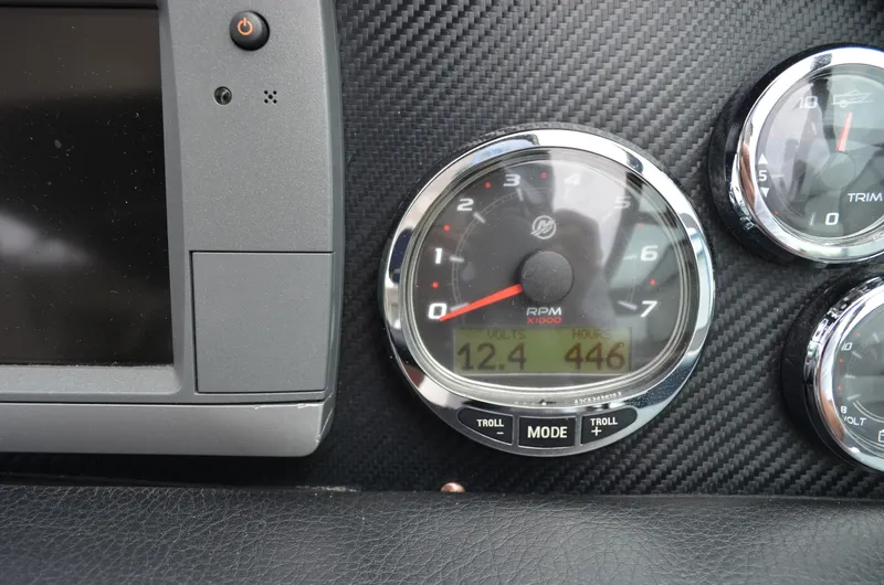 Slide: The Image of Close-up of 2013 Four Winns H310 boat dashboard with RPM gauge and digital display. - 36