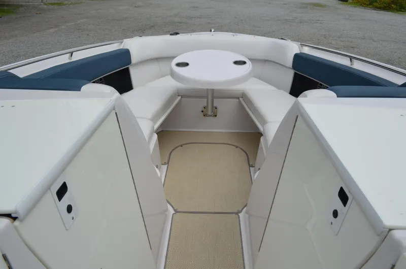Slide: The Image of 2013 Four Winns H310 boat interior with white seating and round table. - 39
