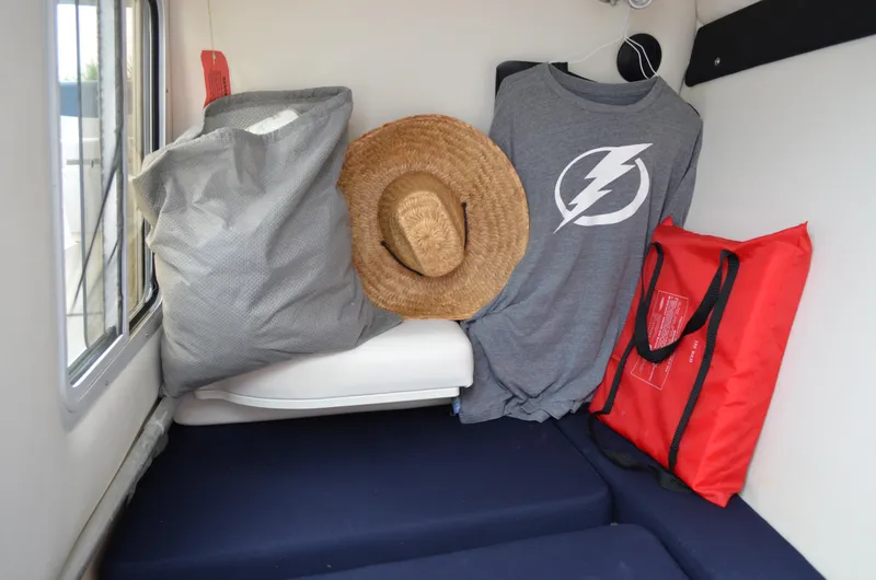 Slide: The Image of Interior of 2013 Four Winns H310 boat with hat, shirt, and bag. - 44