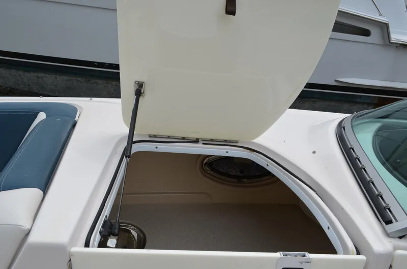 Slide: The Image of Open storage compartment on a 2013 Four Winns H310 boat. - 45