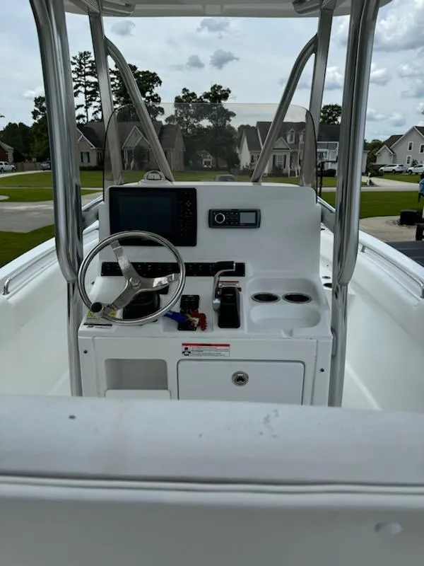 Slide: The Image of 2016 Sea Hunt Ultra 234 boat console with steering wheel and electronics. - 7