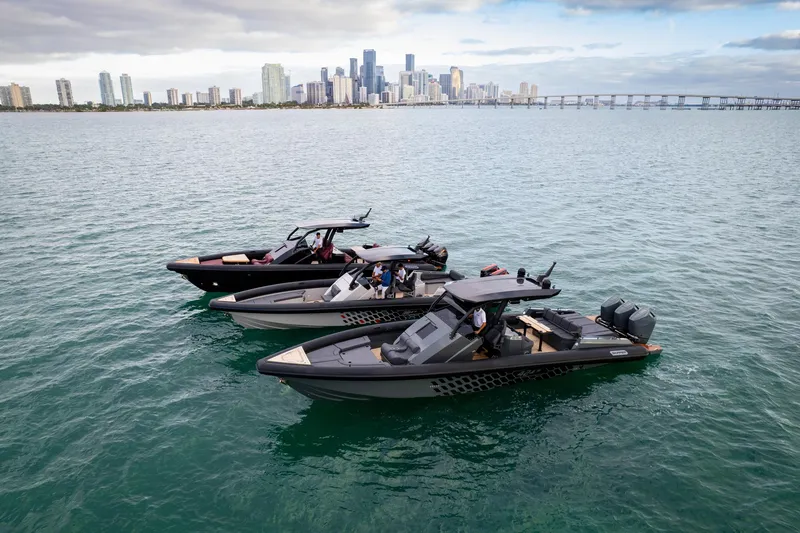 Slide: The Image of Three Skipper-BSK 42 boats on water with city skyline in background, 2024 model. - 11