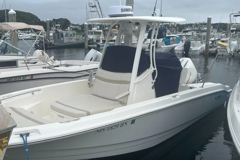 Slide: The Image of 2025 Boston Whaler 220 Dauntless boat docked in a marina. - 1