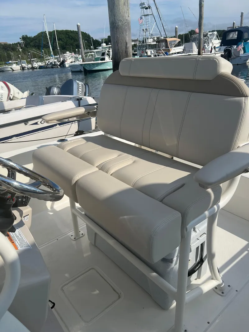 Slide: The Image of 2024 Boston Whaler 220 Dauntless boat seating at marina. - 6
