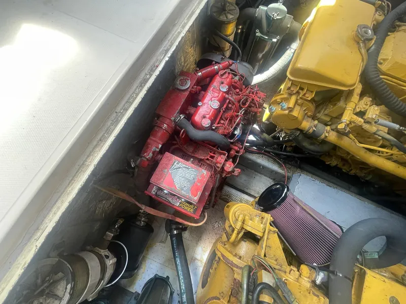 Slide: The Image of Engine compartment of a 1994 Albemarle 32 Express boat showing red and yellow engines. - 15