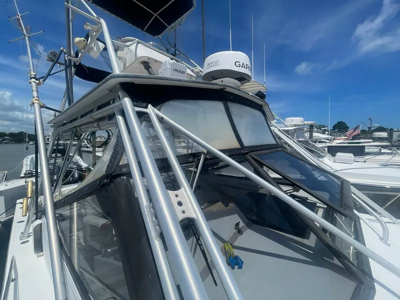 Slide: The Image of 1994 Albemarle 32 Express boat with Garmin radar, docked at a marina under a clear blue sky. - 17