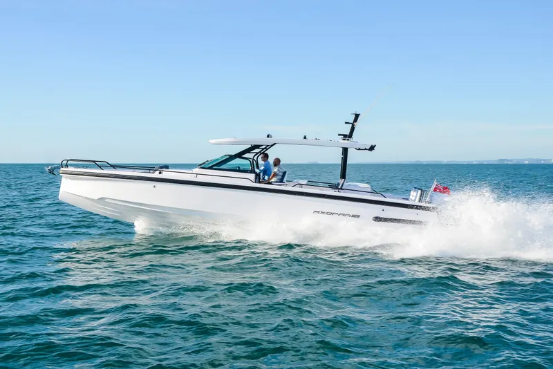 Slide: The Image of 2024 Axopar 37 Sun Top cruising on open water. - 1
