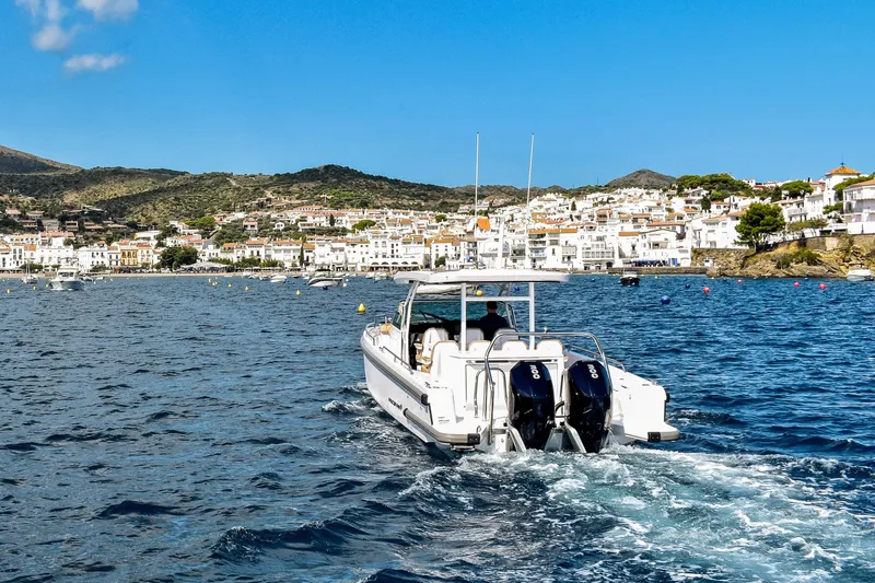 Slide: The Image of 2024 Axopar 37 Sun Top cruising on scenic coastal waters. - 6