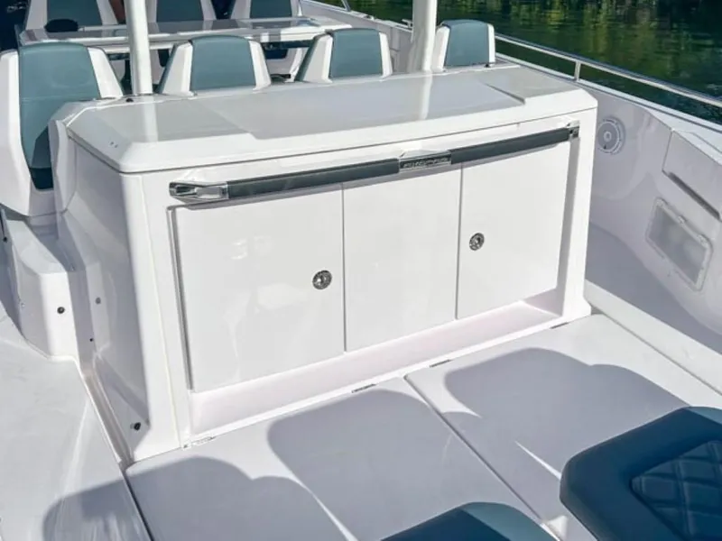 Slide: The Image of 2024 Axopar 37 Sun Top boat interior with sleek white cabinetry. - 19