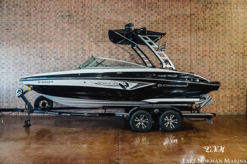 Slide: The Image of 2022 Crownline 220 SS SURF boat on trailer at Lake Norman Marina. - 1