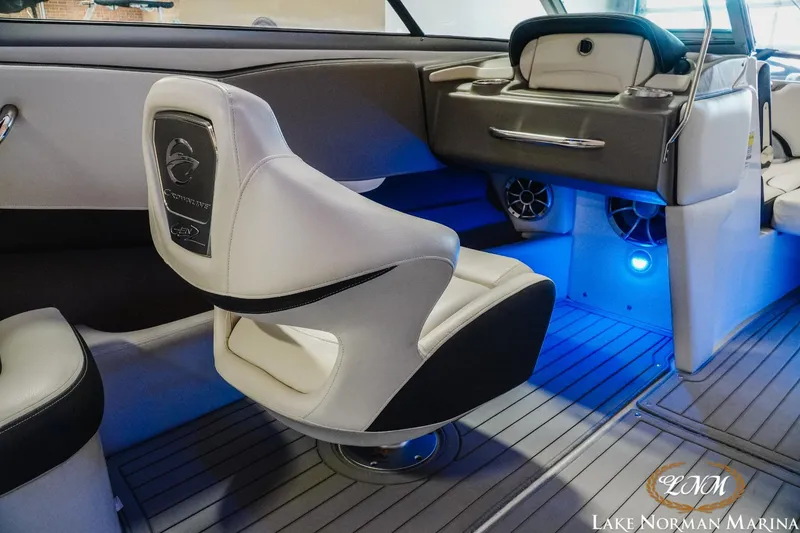 Slide: The Image of 2022 Crownline 220 SS SURF boat interior with modern seating and blue LED lighting. - 16