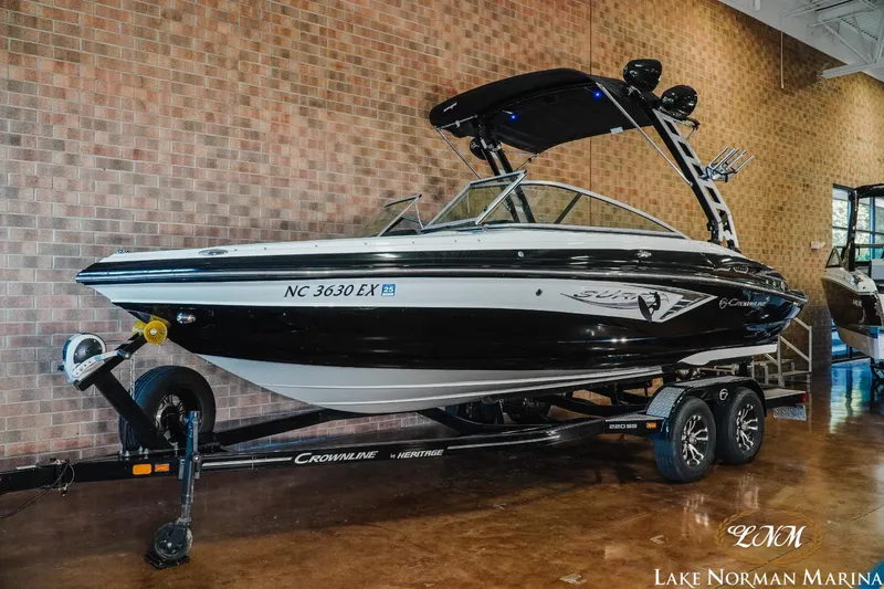 Slide: The Image of 2022 Crownline 220 SS SURF boat on trailer at Lake Norman Marina. - 2