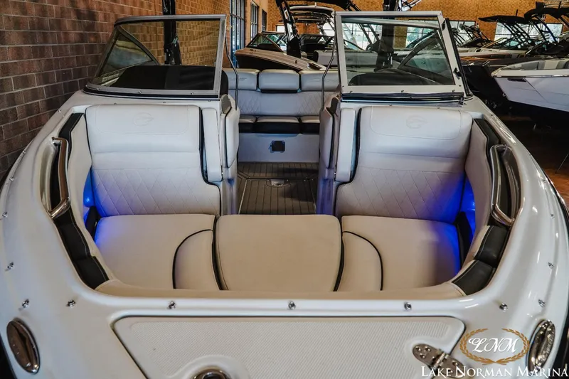 Slide: The Image of 2022 Crownline 220 SS SURF boat interior with white seating and blue accent lighting. - 7