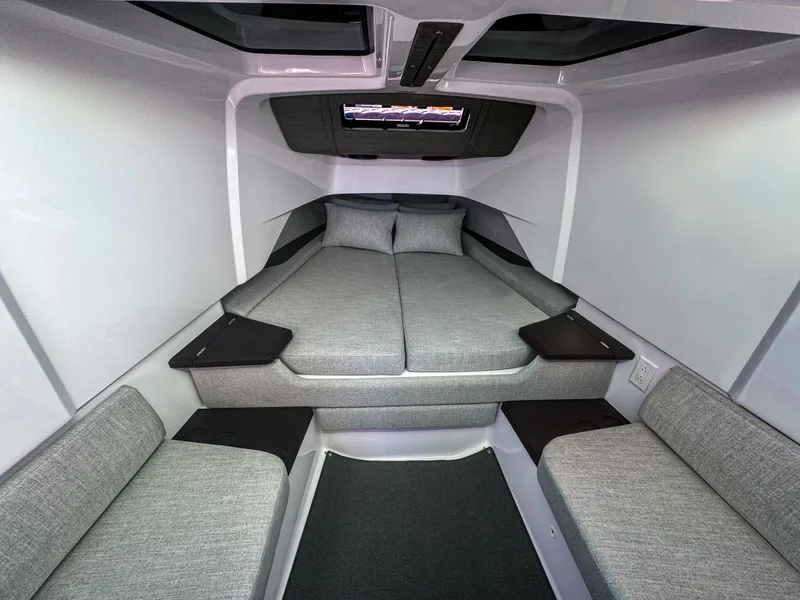 Slide: The Image of 2024 Axopar 37 Sun Top cabin interior with modern gray upholstery and sleek design. - 11