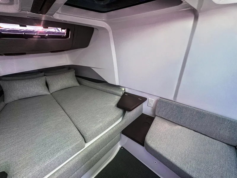 Slide: The Image of 2024 Axopar 37 Sun Top cabin interior with modern gray seating and bedding. - 12
