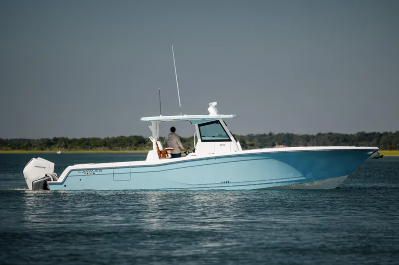 Slide: The Image of 2022 Caymas 401 CC boat cruising on a calm lake. - 1