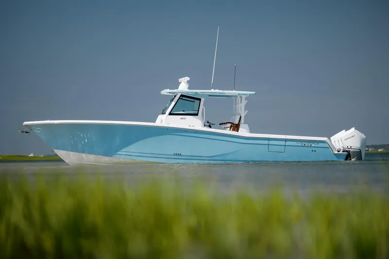 Slide: The Image of 2022 Caymas 401 CC boat on calm water with clear blue sky. - 10