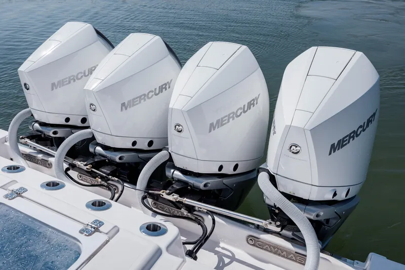 Slide: The Image of Four Mercury outboard engines on a 2022 Caymas 401 CC boat. - 11