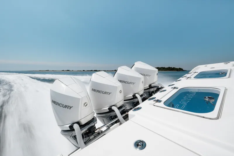 Slide: The Image of 2022 Caymas 401 CC boat with four Mercury outboard engines. - 12