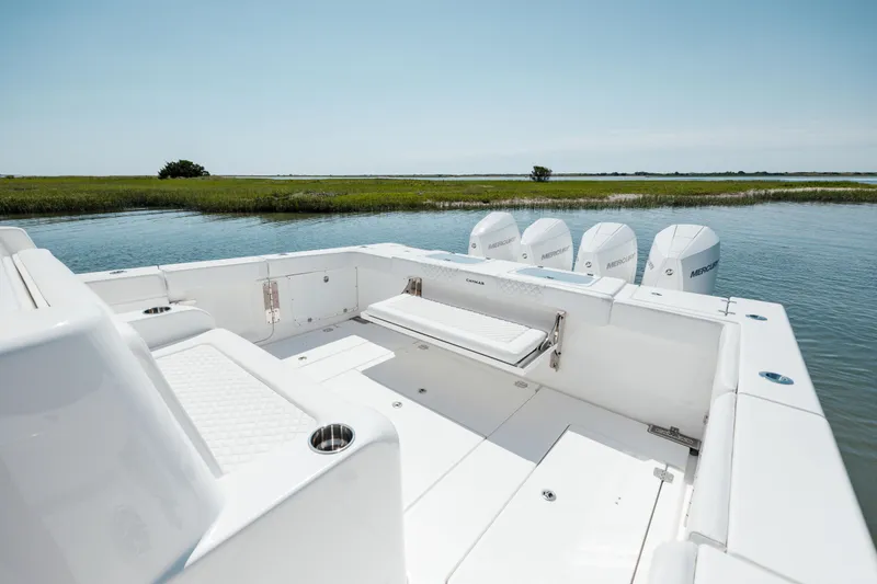 Slide: The Image of 2022 Caymas 401 CC boat with quad engines on a serene waterway. - 18