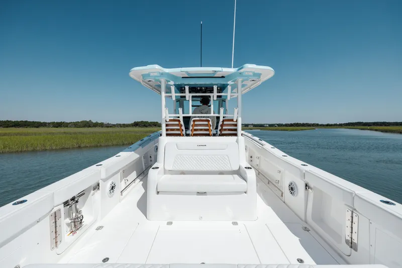 Slide: The Image of 2022 Caymas 401 CC boat on calm water with clear blue sky. - 19