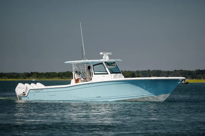 Slide: The Image of 2022 Caymas 401 CC boat cruising on water. - 2
