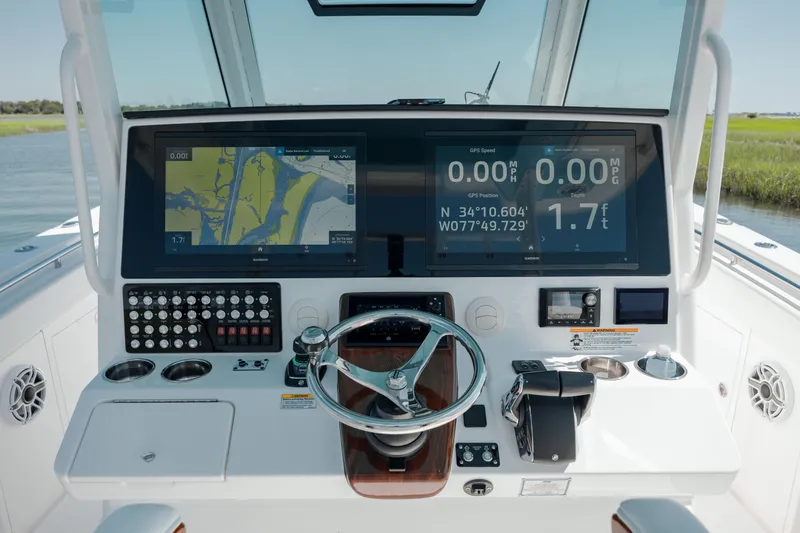 Slide: The Image of 2022 Caymas 401 CC boat dashboard with navigation and control systems. - 23