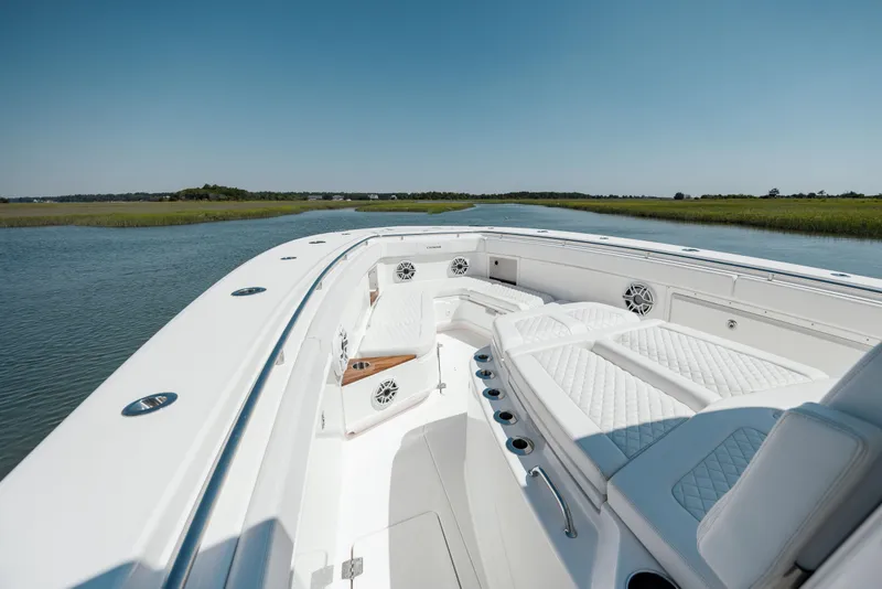 Slide: The Image of 2022 Caymas 401 CC boat on calm water with luxurious seating. - 24