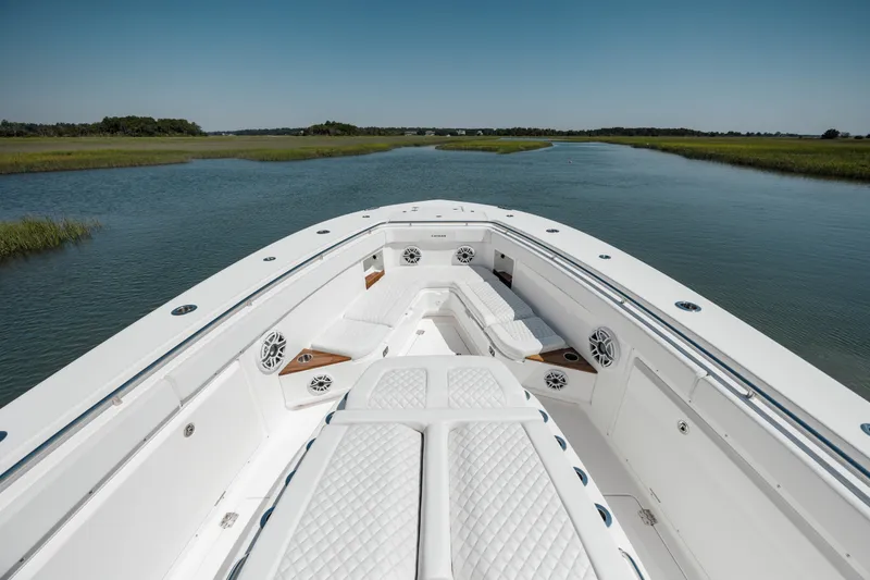 Slide: The Image of 2022 Caymas 401 CC boat on a serene waterway. - 26