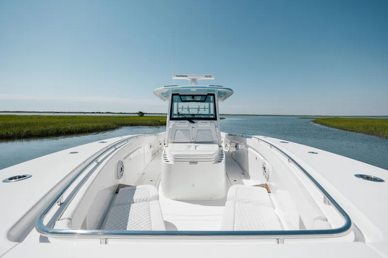 Slide: The Image of 2022 Caymas 401 CC boat on a serene waterway. - 27