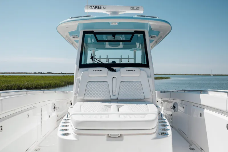 Slide: The Image of 2022 Caymas 401 CC boat with Garmin electronics, white seating, and spacious deck. - 28