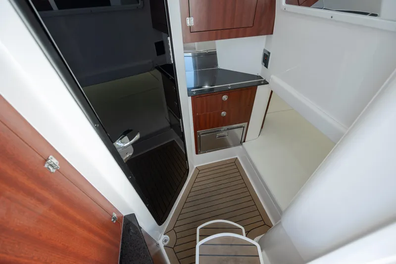 Slide: The Image of 2022 Caymas 401 CC cabin interior with wood cabinetry and stainless steel countertop. - 31