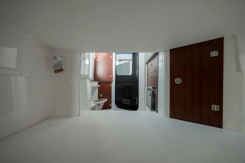 Slide: The Image of Interior cabin of 2022 Caymas 401 CC boat with wooden cabinets and a toilet. - 33