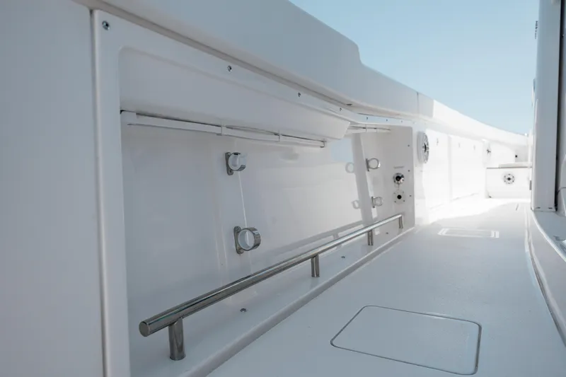 Slide: The Image of 2022 Caymas 401 CC boat interior with storage compartments and stainless steel railings. - 39