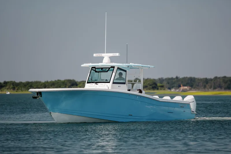 Slide: The Image of 2022 Caymas 401 CC boat cruising on a calm lake. - 4