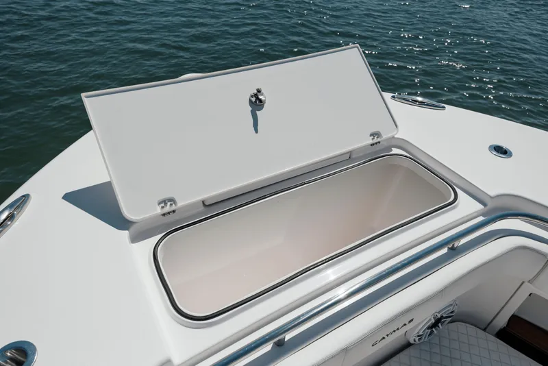 Slide: The Image of 2022 Caymas 401 CC boat storage compartment open on the water. - 46