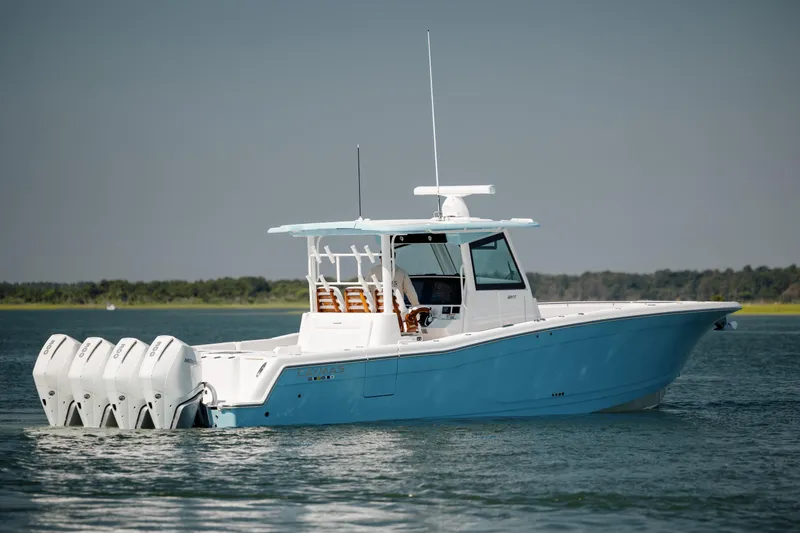 Slide: The Image of 2022 Caymas 401 CC boat with four outboard engines on the water. - 5