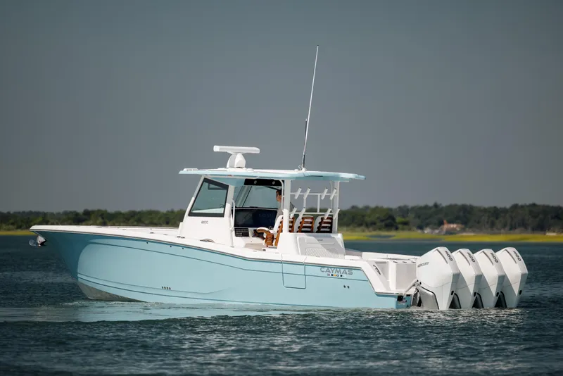 Slide: The Image of 2022 Caymas 401 CC boat on water with four outboard engines. - 6