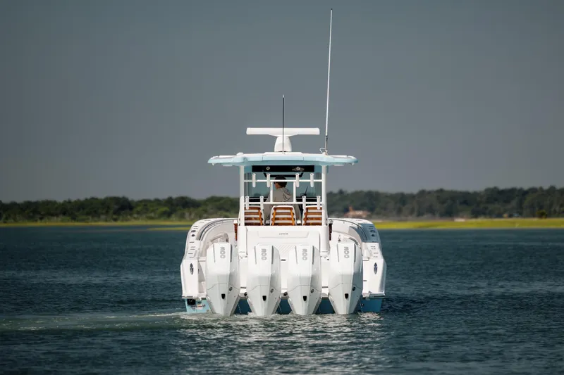 Slide: The Image of 2022 Caymas 401 CC boat with multiple outboard engines on the water. - 7