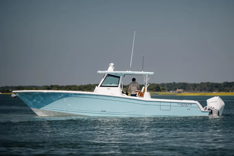Slide: The Image of 2022 Caymas 401 CC boat on calm water with a person onboard. - 8