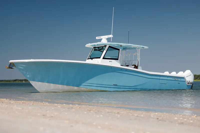 Slide: The Image of 2022 Caymas 401 CC boat anchored on a sandy shore. - 9