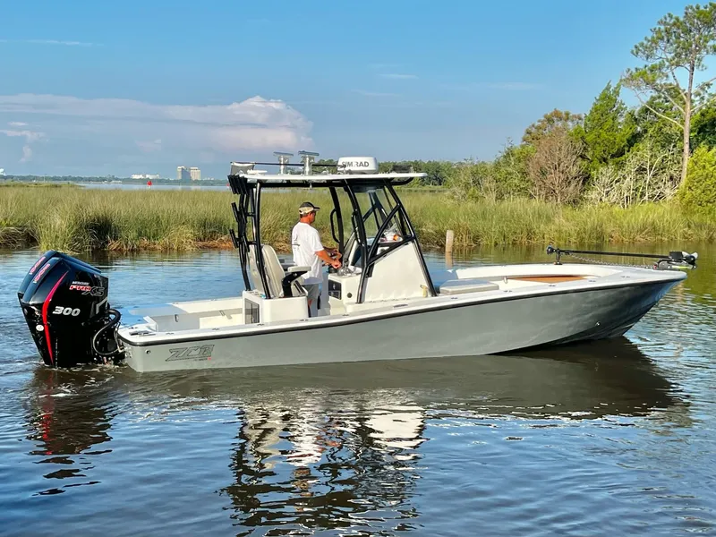 Slide: The Image of 2021 ZCB 26 Freemason boat cruising on a calm river with lush greenery. - 4