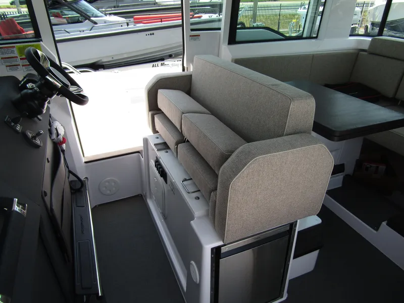 Slide: The Image of Interior of 2024 Axopar 37XC CROSS CABIN with seating and helm station. - 11