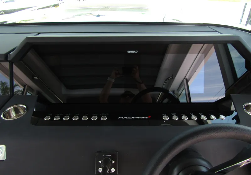 Slide: The Image of 2024 Axopar 37XC CROSS CABIN dashboard with Simrad display and control buttons. - 13