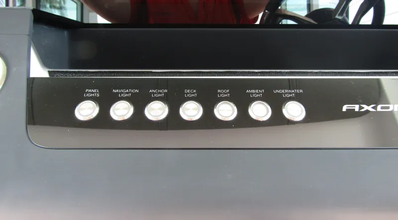 Slide: The Image of Control panel of 2024 Axopar 37XC CROSS CABIN with various light switches. - 14