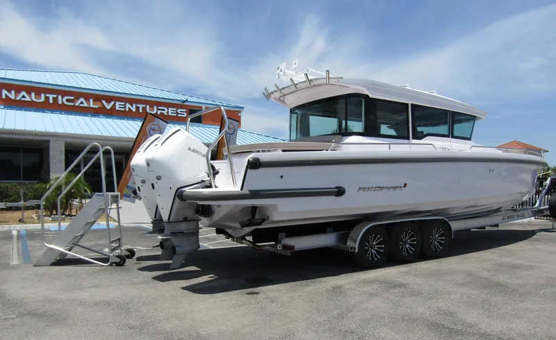 Slide: The Image of 2024 Axopar 37XC CROSS CABIN boat on a trailer at Nautical Ventures. - 2
